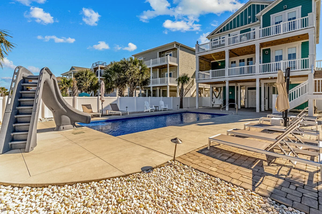 Pool with waterslide beside the beach house