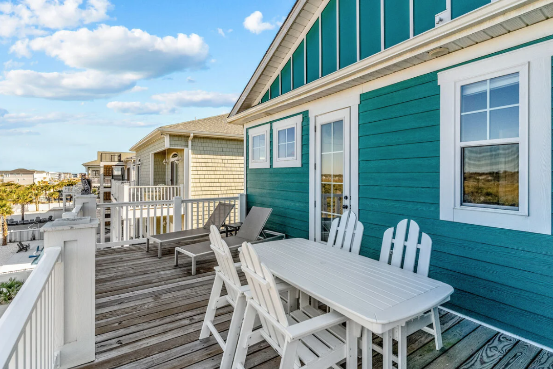 Rear deck with dining table and lounge chairs