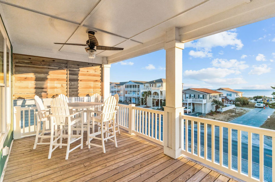 Third floor balcony with high-top table and ocean view